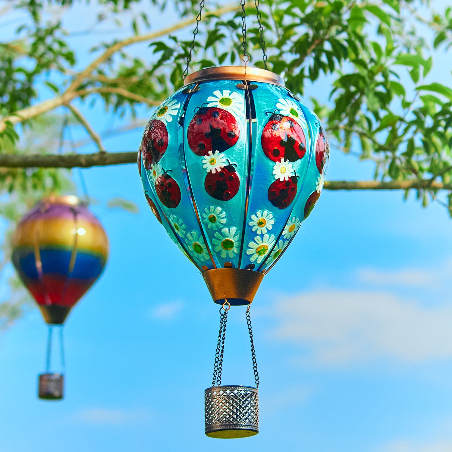 Garden solar decor featuring a hand-painted beetle balloon lantern hanging over a patio, great for patio decor ideas