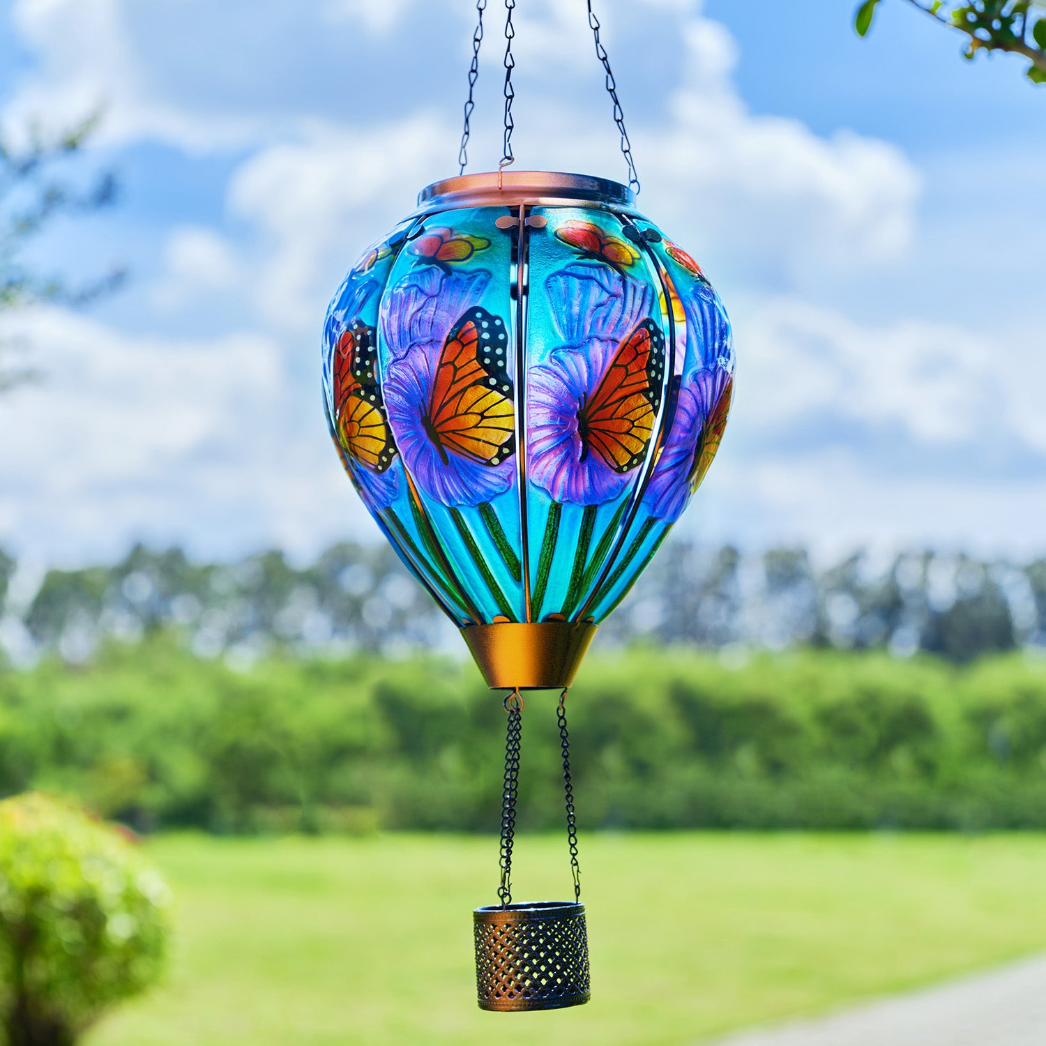 Butterfly balloon solar lantern illuminating a flowerbed, perfect for backyard lights and garden solar decor