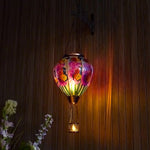 Hand-painted butterfly solar hot air balloon lantern for backyard decorations, patio decor, and garden solar lights with a warm flame-effect glow