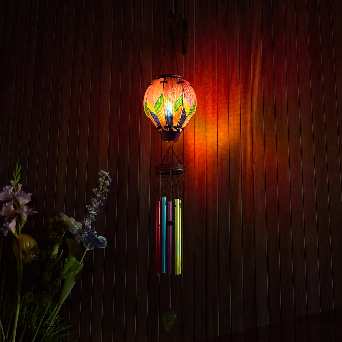 Hand-painted colorful solar balloon lantern with wind chime, ideal for yard decoration, patio solar décor, and garden lighting with flame-effect LED
