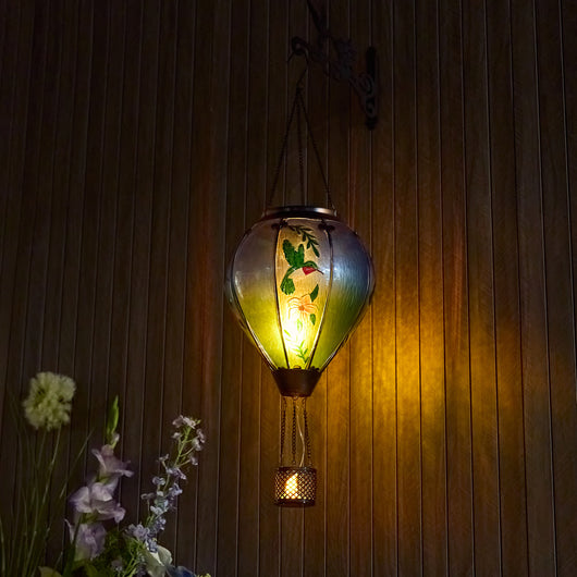 Hand-painted hummingbird glass solar hot air balloon lantern for backyard decorations, patio décor, and garden solar lights with warm flame-effect LED glow