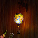 Outdoor glass solar balloon lantern with a peacock feather design, ideal for front yard decorations, backyard décor, and warm flame-effect garden solar lighting