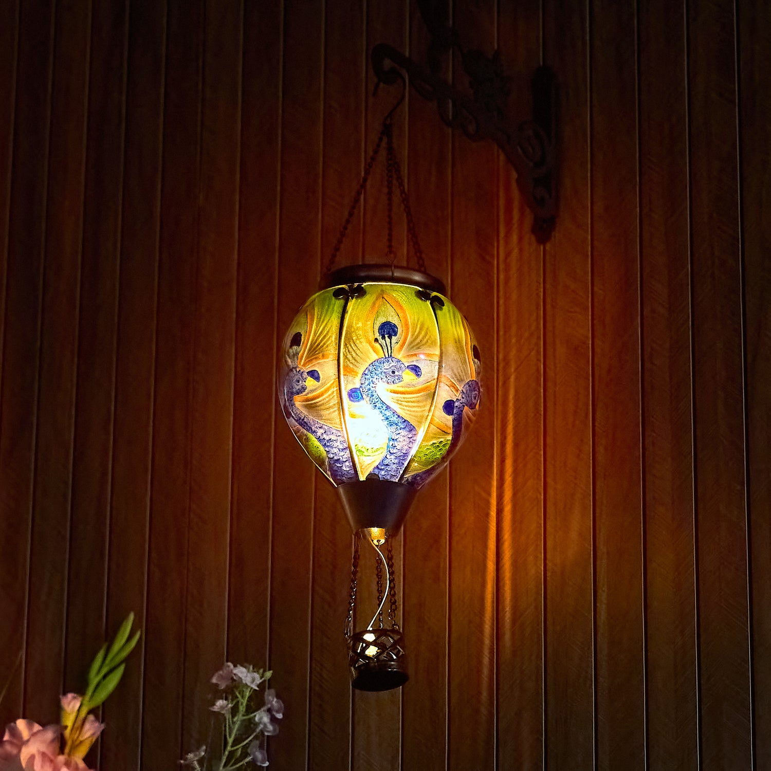 Outdoor glass solar balloon lantern with a peacock feather design, ideal for front yard decorations, backyard décor, and warm flame-effect garden solar lighting