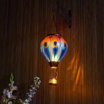 Hand-painted peacock feather solar balloon lantern for yard décor, backyard decorations, and patio solar lighting featuring a warm flame-effect solar LED