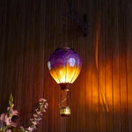Purple hand-painted solar hot air balloon lantern for backyard decorations, patio decor, and garden solar lights with a warm flame-effect glow