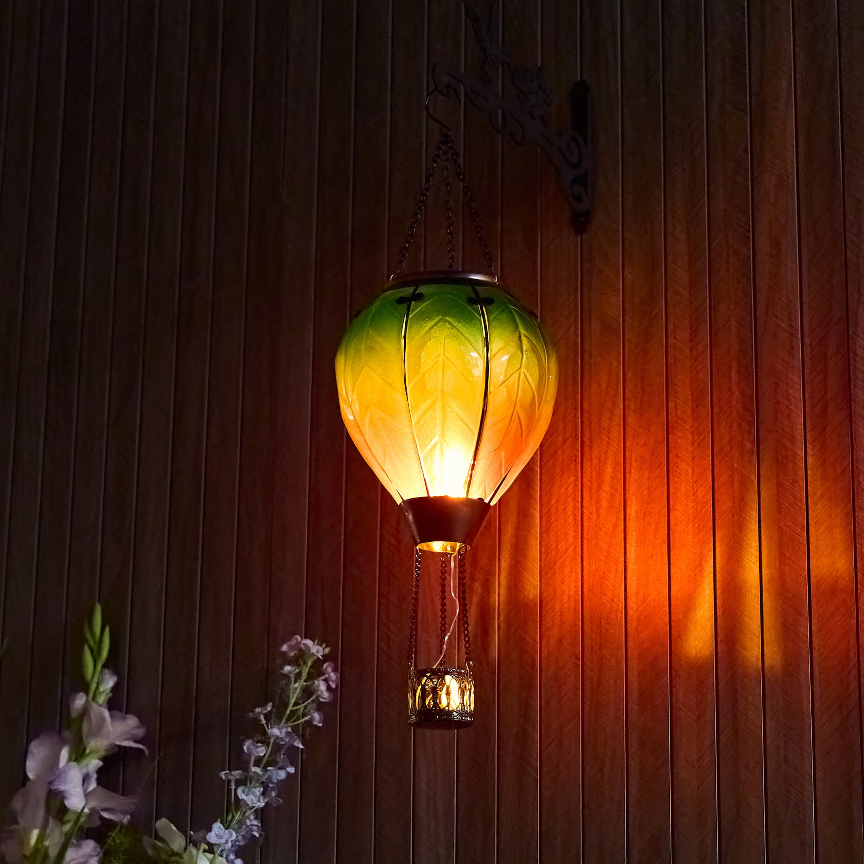 Hand-painted rainbow glass solar hot air balloon lantern for yard décor, backyard solar lights, and patio decorations with warm flame-effect illumination