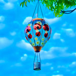 Garden solar decor featuring a hand-painted beetle balloon lantern hanging over a patio, great for patio decor ideas