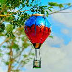 Butterfly-themed solar lantern with flame effect lighting up a cozy backyard, perfect for backyard solar lights and yard decor