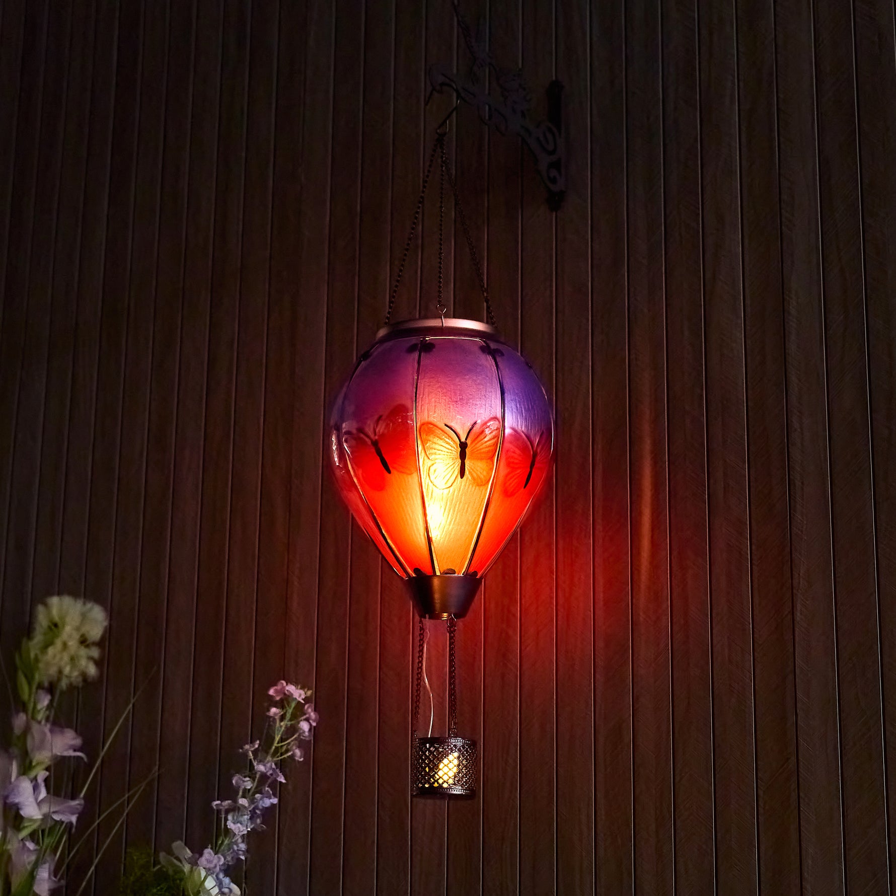 Hanging butterfly solar balloon lantern over flowers, perfect for garden solar decor and front yard decorations