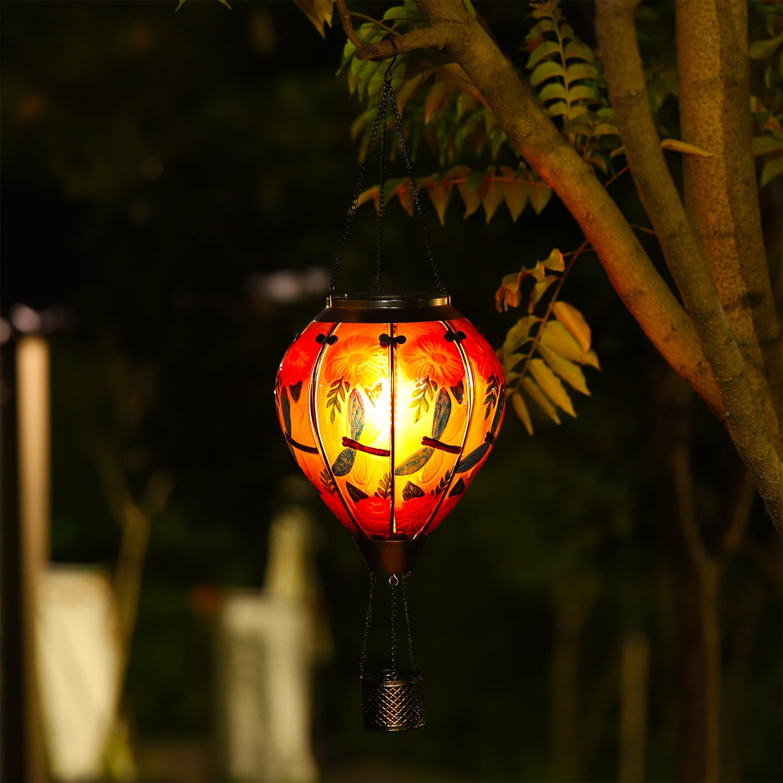 Colorful dragonfly design lighting up as a solar garden lantern, enhancing backyard solar decorations