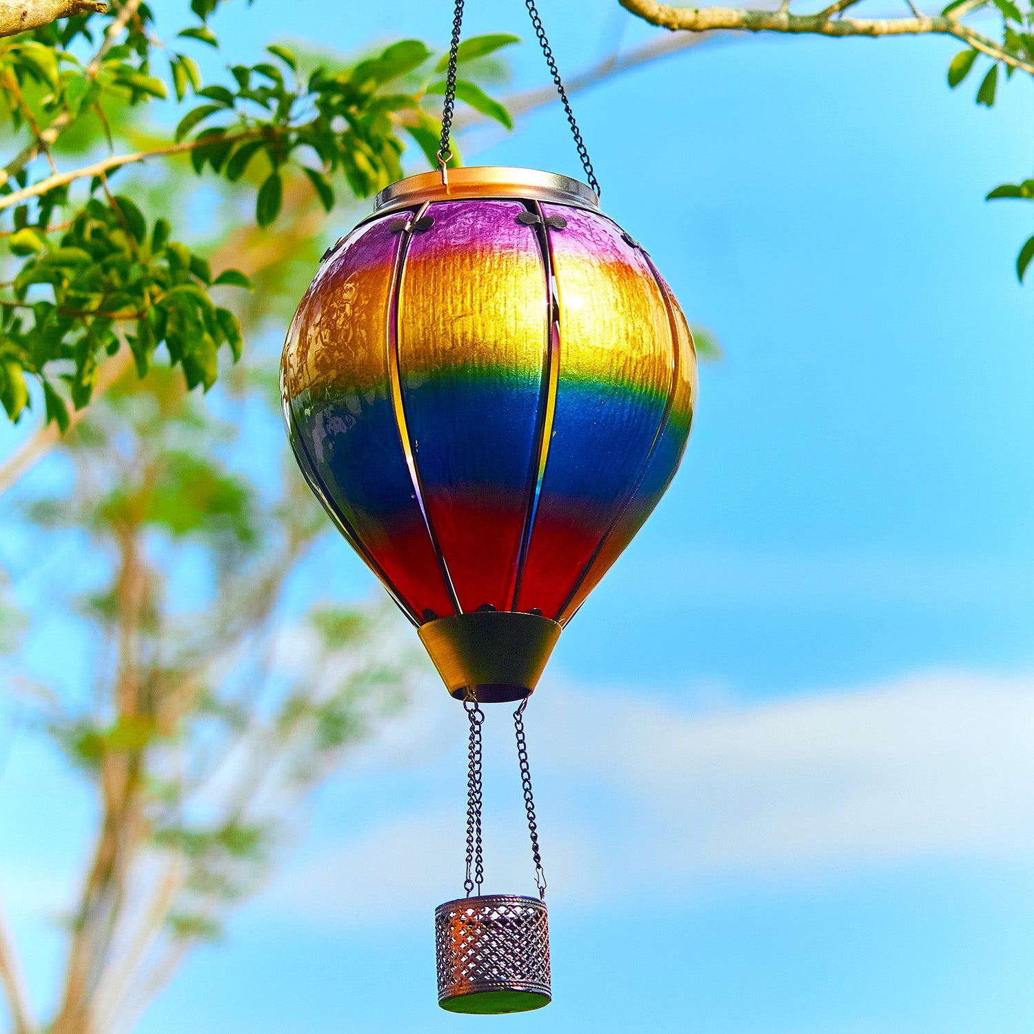 Colorful rainbow solar lantern hanging above patio seating, creating magical patio decor ideas and backyard solar lights