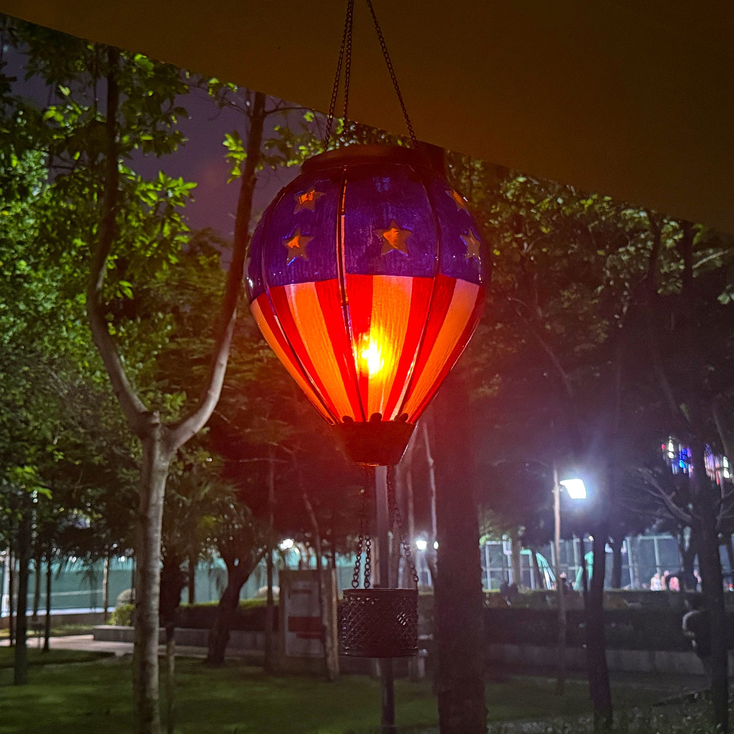 hand-painted solar hot air balloon lantern enhancing front yard decor and garden ambiance