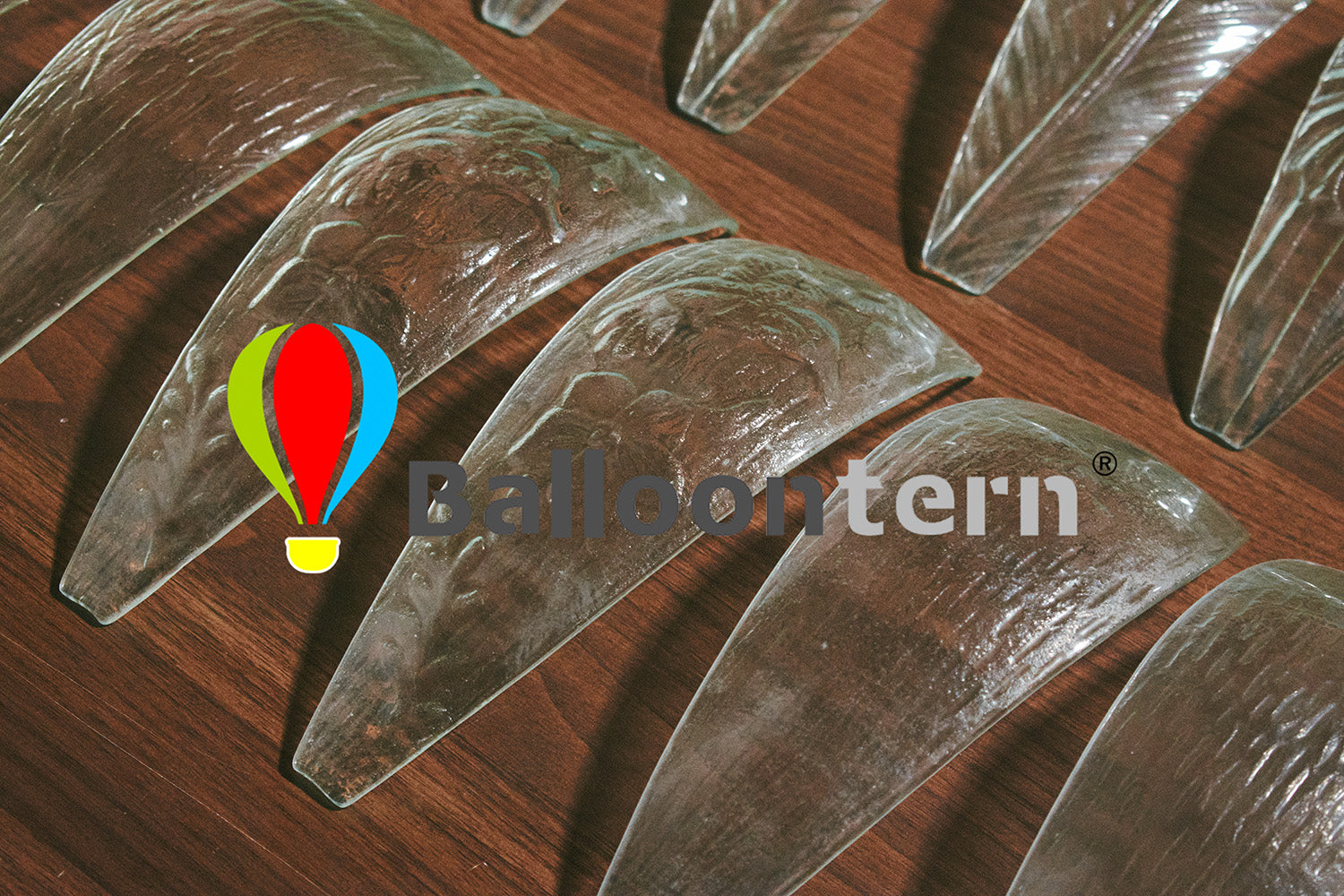 Artisan hand-painting colorful designs on hot air balloon-shaped glass panels for solar garden lanterns