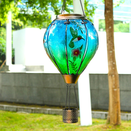 Hummingbird balloon solar lantern hanging from an outdoor hook