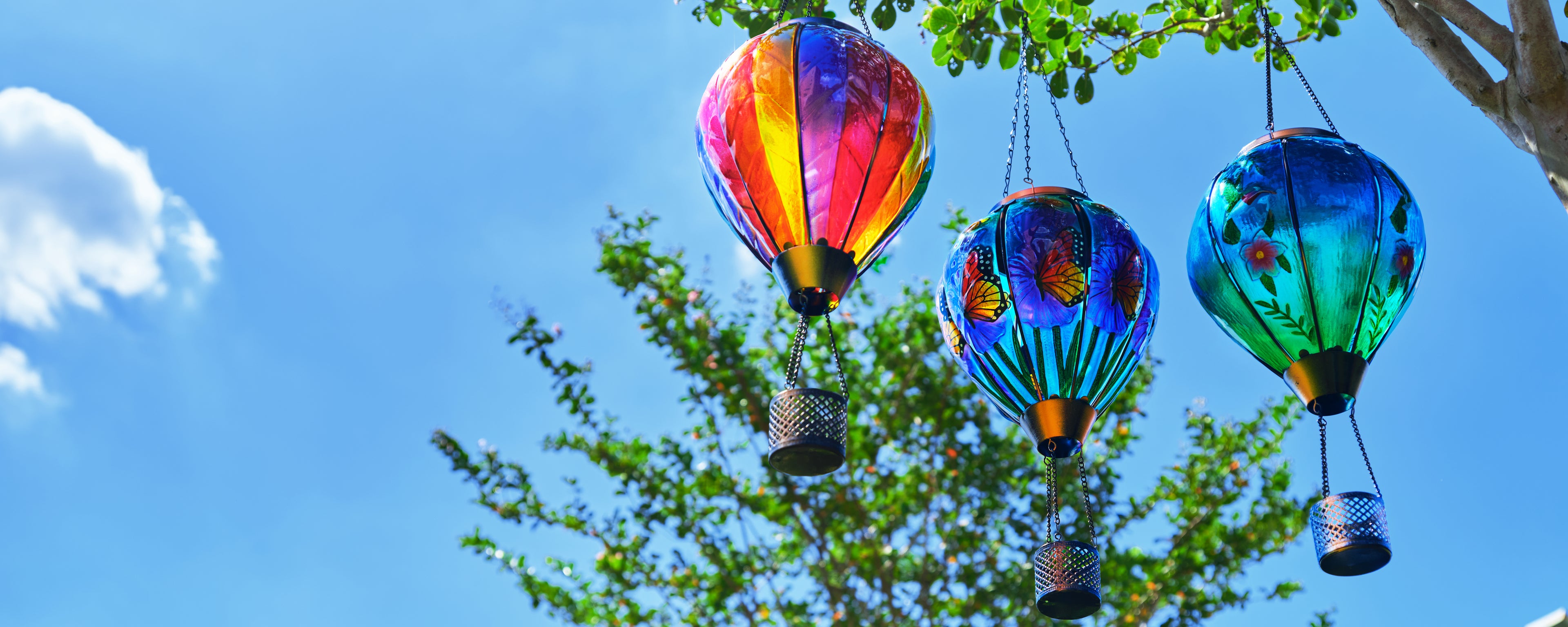cluster of hanging solar balloon lanterns adding charm to patio solar decorations