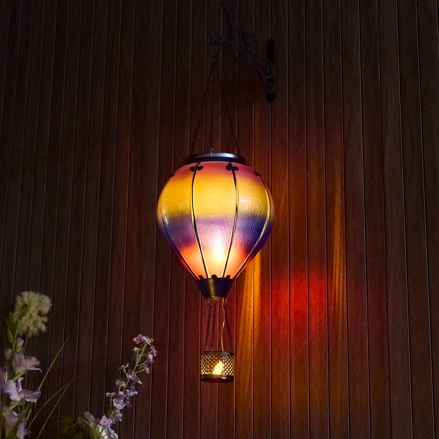 Hanging solar lantern with rainbow hues, designed for garden solar lanterns and backyard solar flame lamp accents