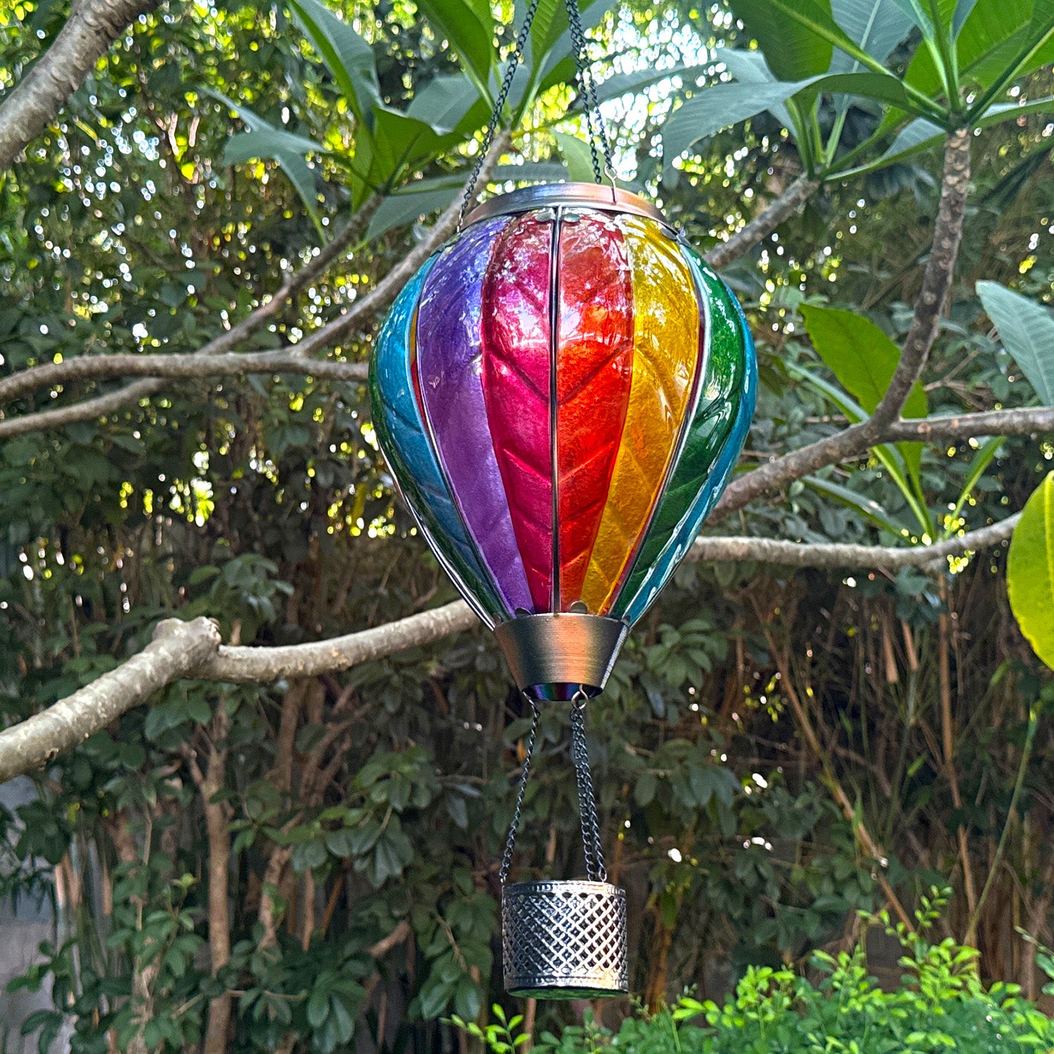 hand-painted rainbow solar lantern in daylight, perfect for front yard decor