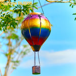 Colorful solar lantern with rainbow gradient panels glowing in a backyard garden, ideal for backyard decorations and yard lights