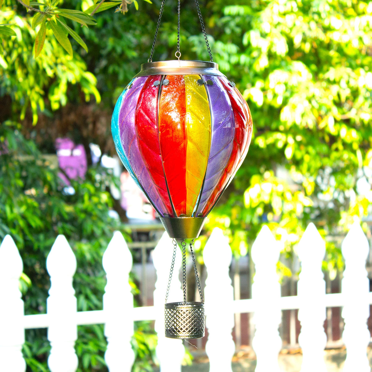 Rainbow hot air balloon solar lantern adding cheerful color to an outdoor yard
